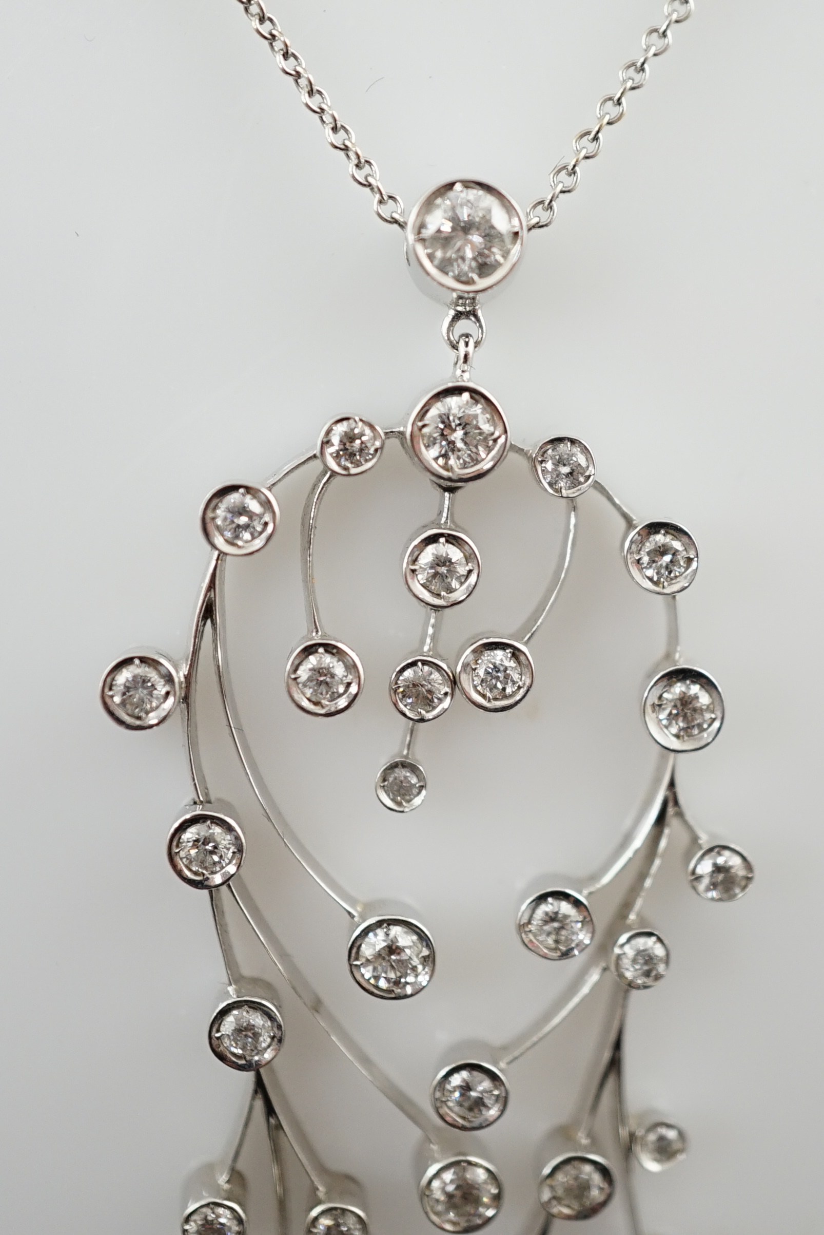 A modern 18ct white gold and diamond cluster set drop pendant on chain, together with a pair of matching drop earrings